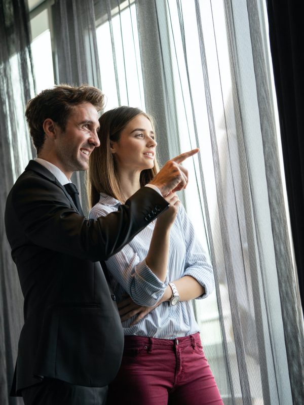 Handsome business man explaining his vision or idea to colleague